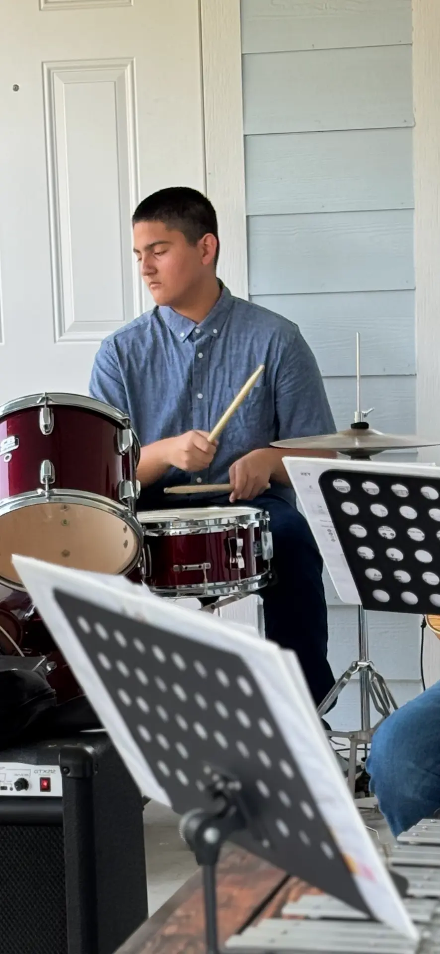 Young drummer playing during Sunday worship