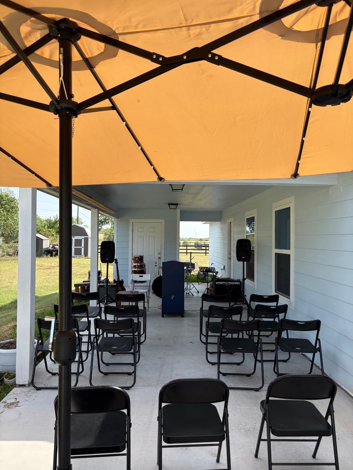 Chairs set up under the porch for a Sunday evening gathering in Lyford, Texas
